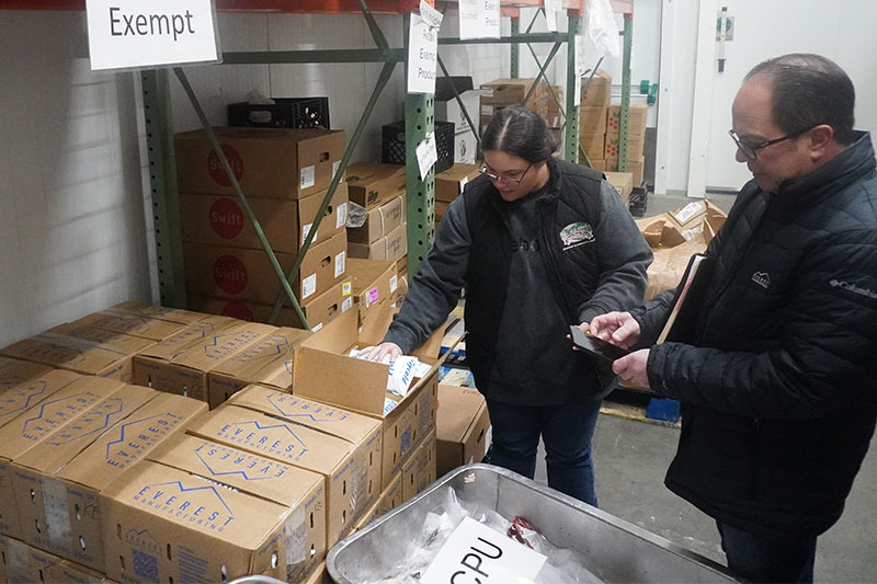 Workers inspecting contents of a box